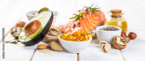 Selection of healthy unsaturated fats, omega 3 - fish, avocado, olives, nuts and seeds photo