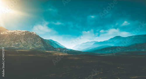 epic landscape scene with high contrasted sky and mountains and sunlight on the left side