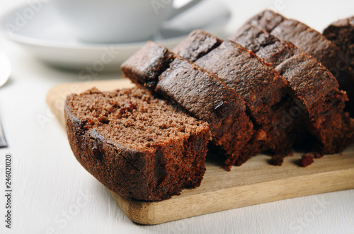 Chocolate muffin sliced on a wooden table. Sweet pastries for breakfast