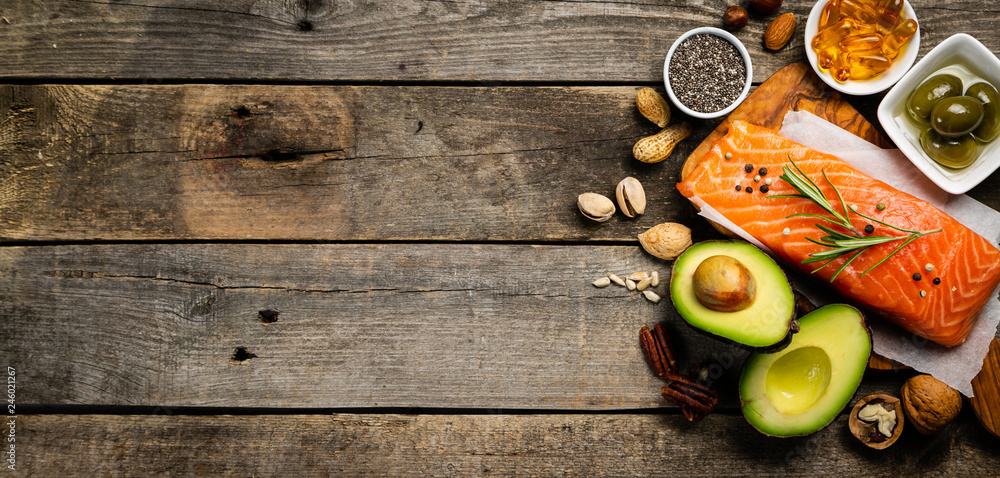 Selection of healthy unsaturated fats, omega 3 - fish, avocado, olives, nuts and seeds Selection of healthy unsaturated fats, omega 3 - fish, avocado, olives, nuts and seeds