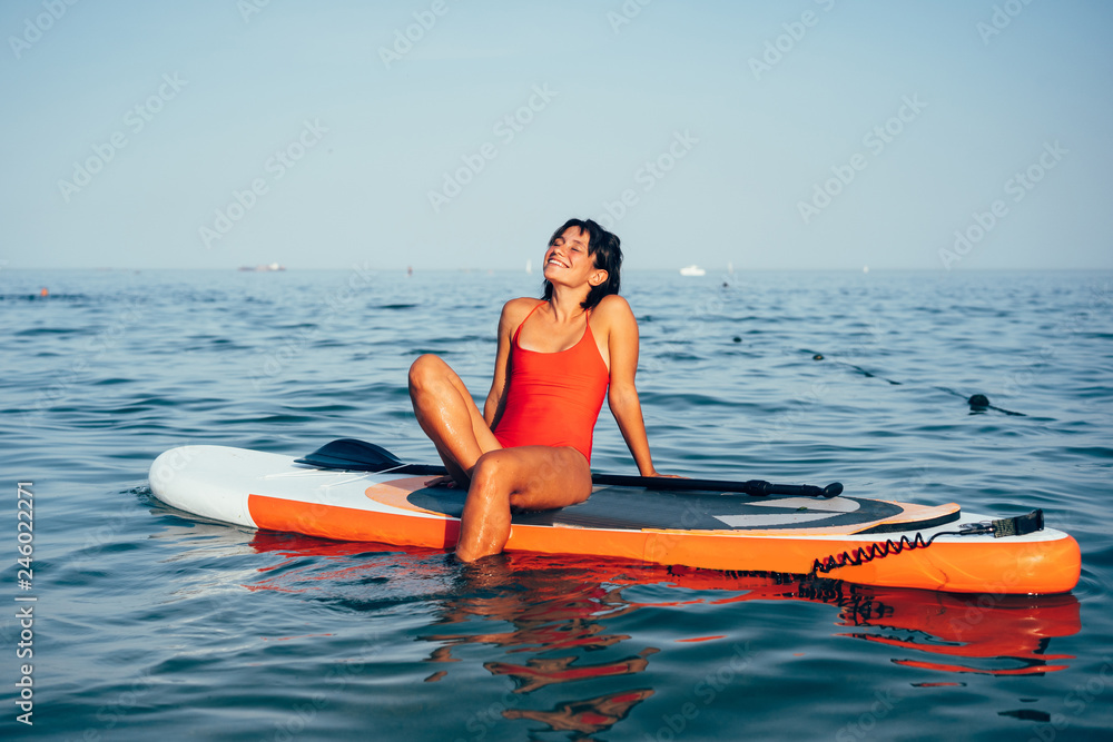 Ταπετσαρία Young woman doing yoga on sup board with paddle