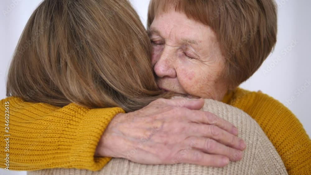 Daughter And Senior Mother Hugging. Close-Up. Daughter And Senior Mother Hugging. Close-Up.