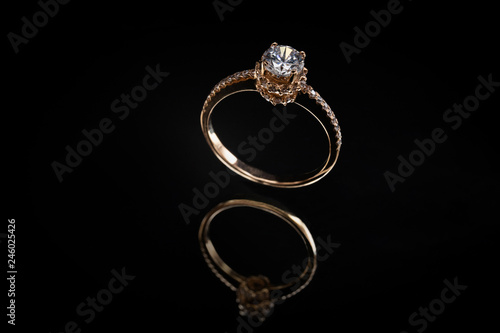 Gold ring with reflection on the mirror black background