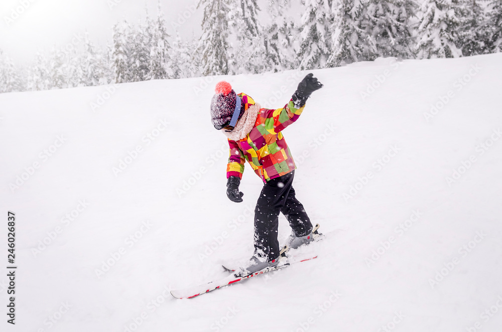 A little boy learn downhill skiing.