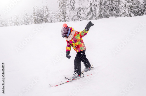A little boy learn downhill skiing.