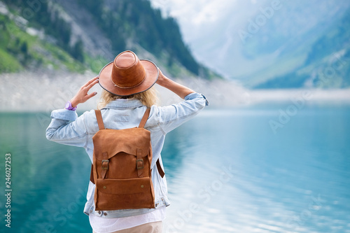 Traveler-Image. Traveler look at the mountain lake. Travel and active life concept. Adventure and travel in the mountains region in the Austria.