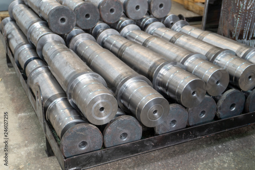 Metal shafts stacked in a row in stock