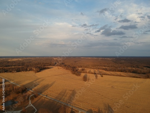 Rural sunset over the hay fields. Shadows seem longer they should be at this time of day.