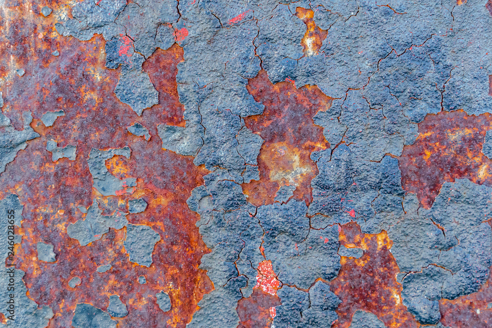 Rusted metal. Rust on a painted metal.  Focus at the center of the image.