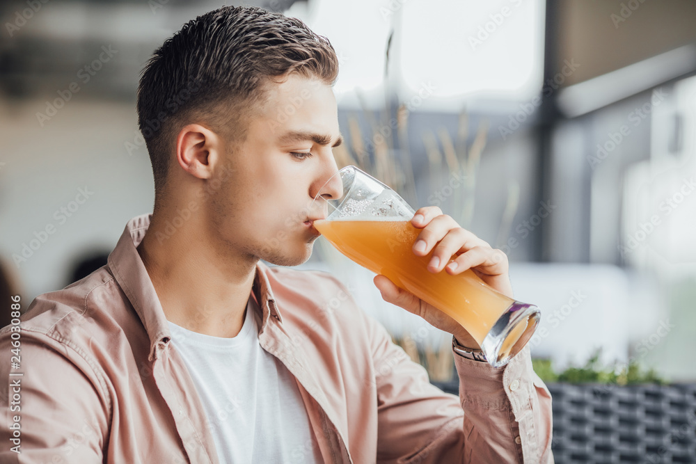 Fototapeta premium One boy drinking beer and testing it
