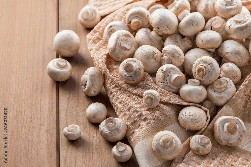 Fresh champignons on a wooden table. Fresh champignons on a wooden table.