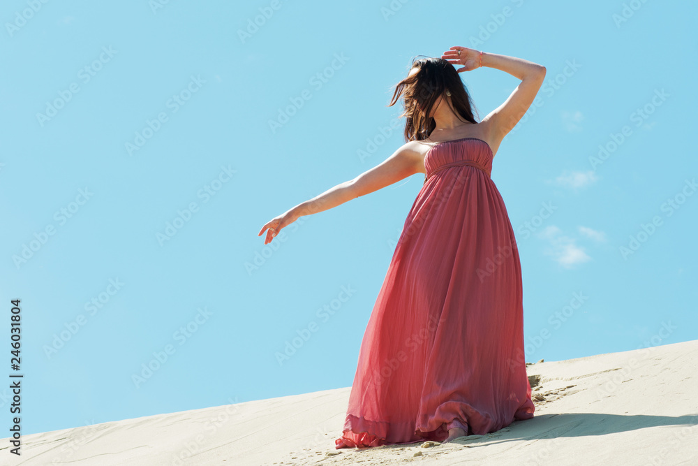 Woman in red waving dress with flying fabric, Beautiful girl spinning