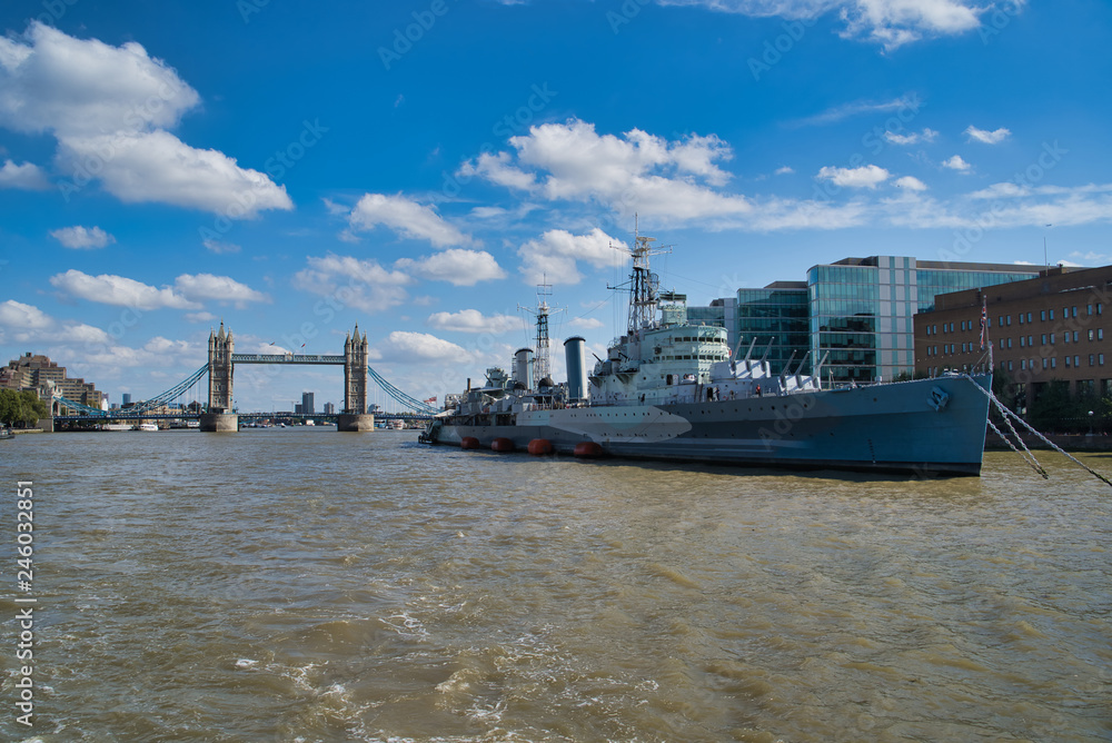 LONDON, UK - SEPTEMBER 9, 2018: Military Cruiser Belfast (HMS Belfast) is the pride of the British fleet moored on the Thames, view of Tower Bridge