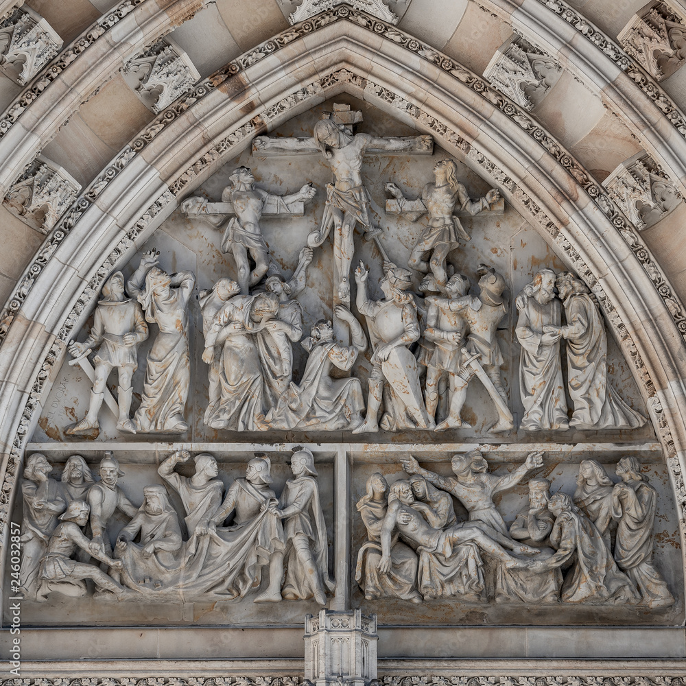 Crucifixion of Christ scene at major entrance portal of Saint Vitus Cathedral in Prague, Czech Republic, details, closeup