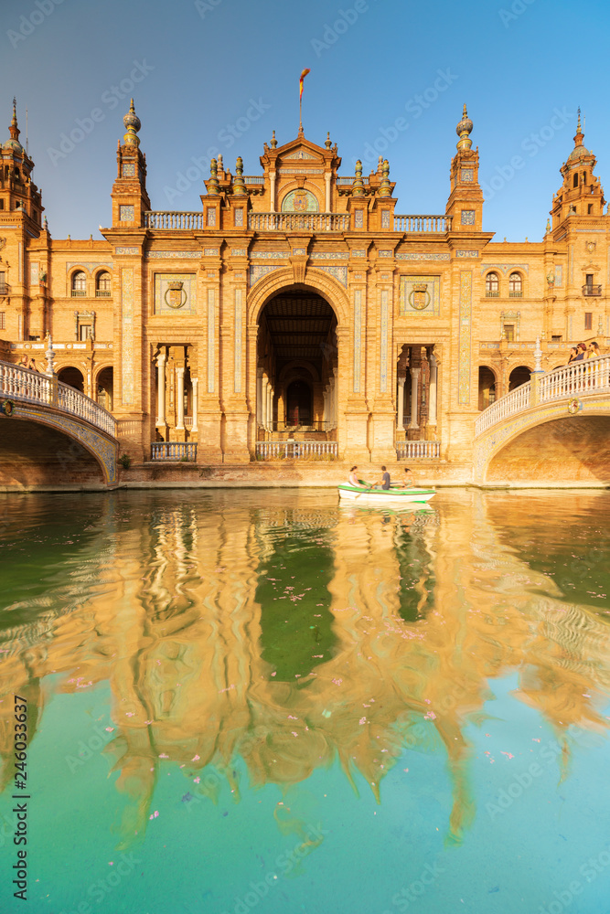 Facade the old palace built in Neo-Mudejar style reflected in the canal, Plaza de Espana, Seville, Andalusia, Spain Facade the old palace built in Neo-Mudejar style reflected in the canal, Plaza de Espana, Seville, Andalusia, Spain
