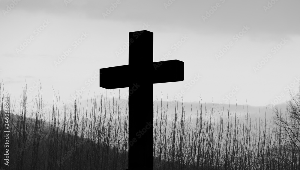 Cross and crucifixion of Jesus Christ silhouette and lonely morning with fog layers, energy forestry, forest hill background. Religious symbolism, Mourning, memories, remembrance and commemoration 