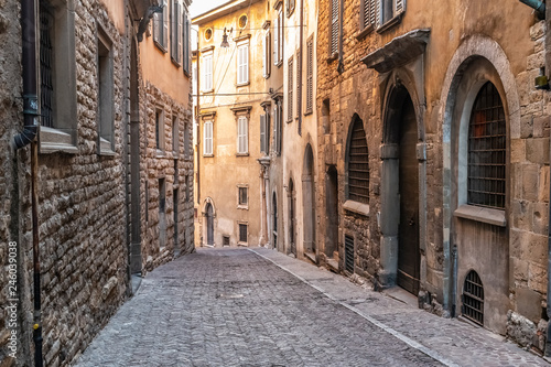 Fototapeta Naklejka Na Ścianę i Meble -  Beatiful Old Medieval European narrow empty street of a medieval town on the morning taken in Bergamo, Citta Alta, Italy