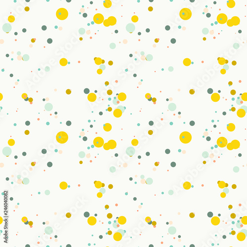 Bright yellow, blue, green, orange messy dots on white background. Festive seamless pattern with round shapes. Grunge dotted texture for wrapping paper, web. Vector illustration.