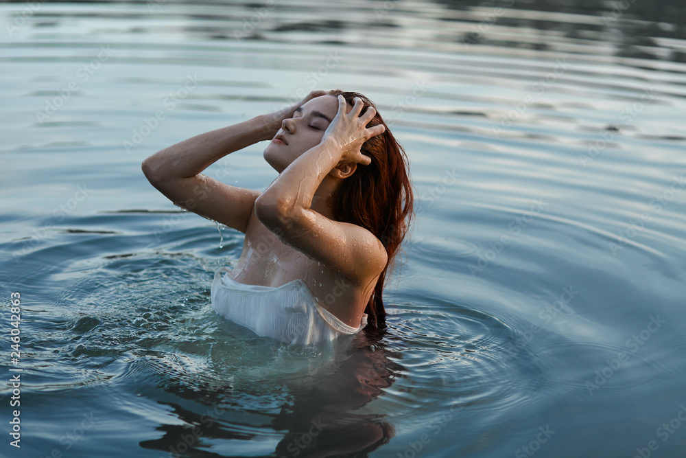 Fototapeta premium redhead girl in the lake