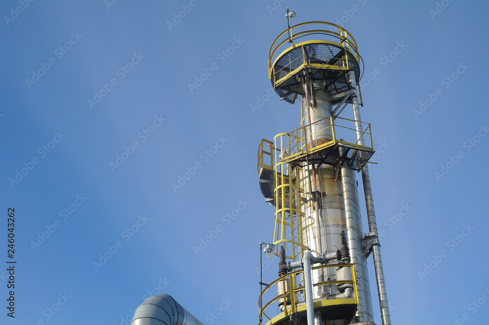 Column tower in petrochemical plant at twilight