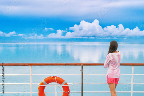 Cruise ship luxury travel woman on deck looking away in Tahiti. Serene still ocean water landscape. Tourism vacation holidays in French Polynesia.