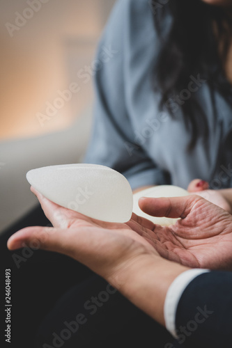 Plastic surgeon and patient discuss choice of breast implants after mastectomy or for breast augmentation. 