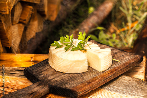 Round cheese on a wooden board