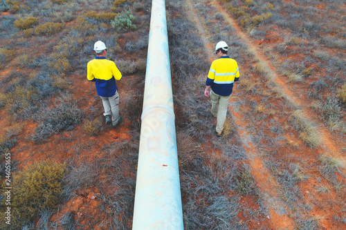 Engineers undertaking a condition assessment of an above ground water pipeline in the Australia outback photo