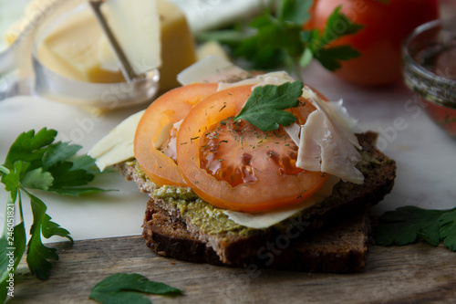 Homemade bruschetta, sandwich with pesto sauce, cheese, tomatoes and spices. Healthy italia nsnack. photo