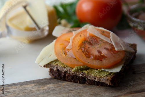 Homemade bruschetta, sandwich with pesto sauce, cheese, tomatoes and spices. Healthy italia nsnack. photo