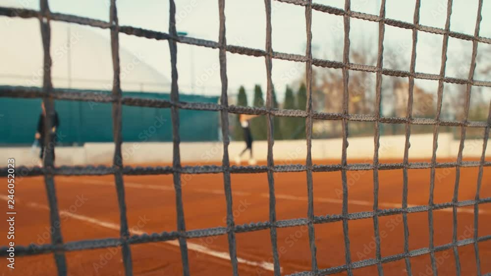 Tennis Players play Tennis On Clay Court, net in front, dolly, 4k, slow motion 75fps Tennis Players play Tennis On Clay Court, net in front, dolly, 4k, slow motion 75fps