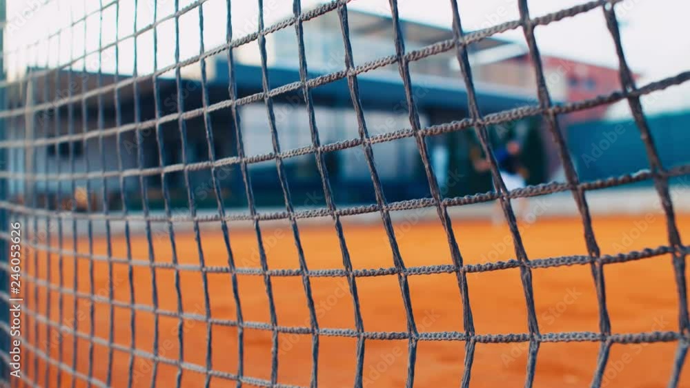 Tennis Player play Tennis On Clay Court, net in front, dolly, 4k, slow motion 75fps Tennis Player play Tennis On Clay Court, net in front, dolly, 4k, slow motion 75fps