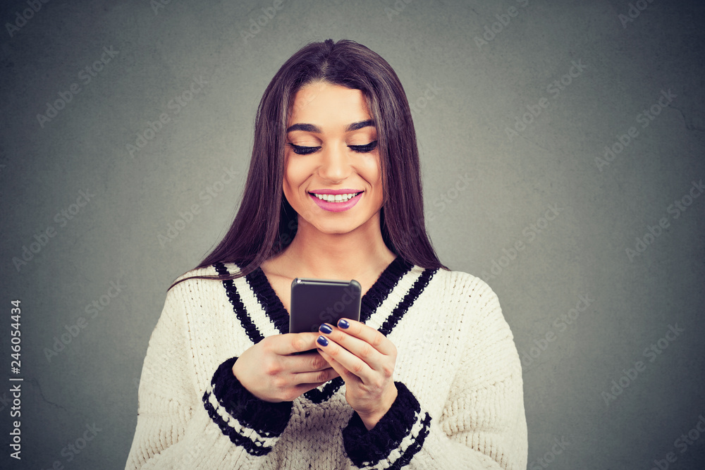 Fototapeta premium Smiling ethnic woman using smartphone