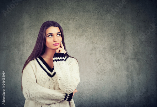 Daydreaming young woman looking away