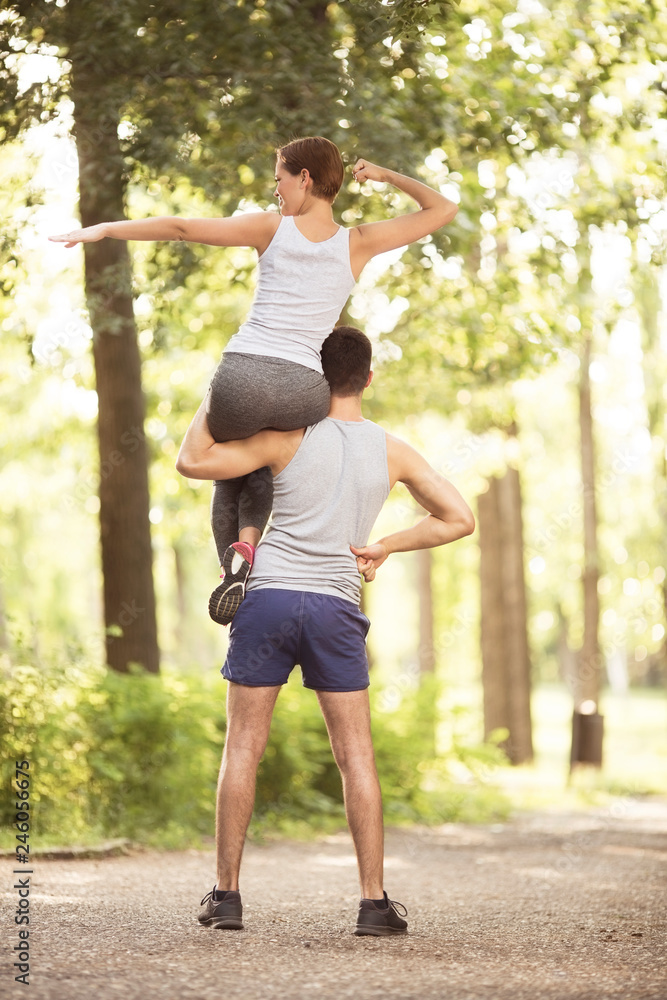 Young couple doing exercises in park Young couple doing exercises in park