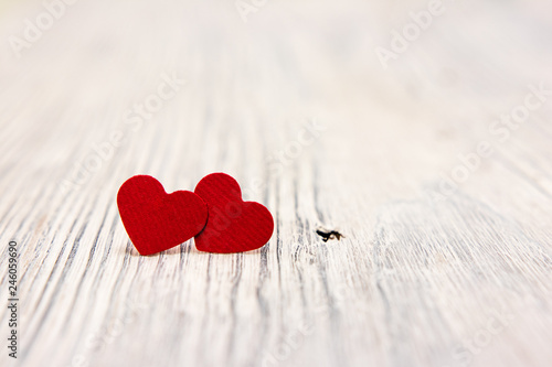 two red hearts on a light wooden background. holiday. congratulations. St. Valentine's Day. wedding.