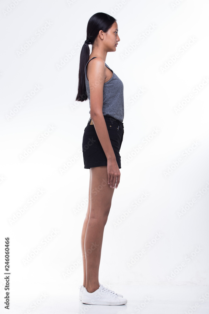 Beautiful Asian Long straight black hair tan skin woman in gray vast slim black short shoes, fresh face, studio lighting white background isolated copy space, full length snap rear side back view Beautiful Asian Long straight black hair tan skin woman in gray vast slim black short shoes, fresh face, studio lighting white background isolated copy space, full length snap rear side back view