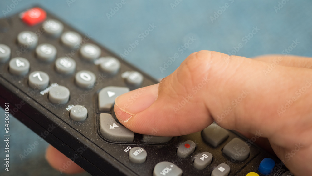 Man press with his finger on remote Man press with his finger on remote