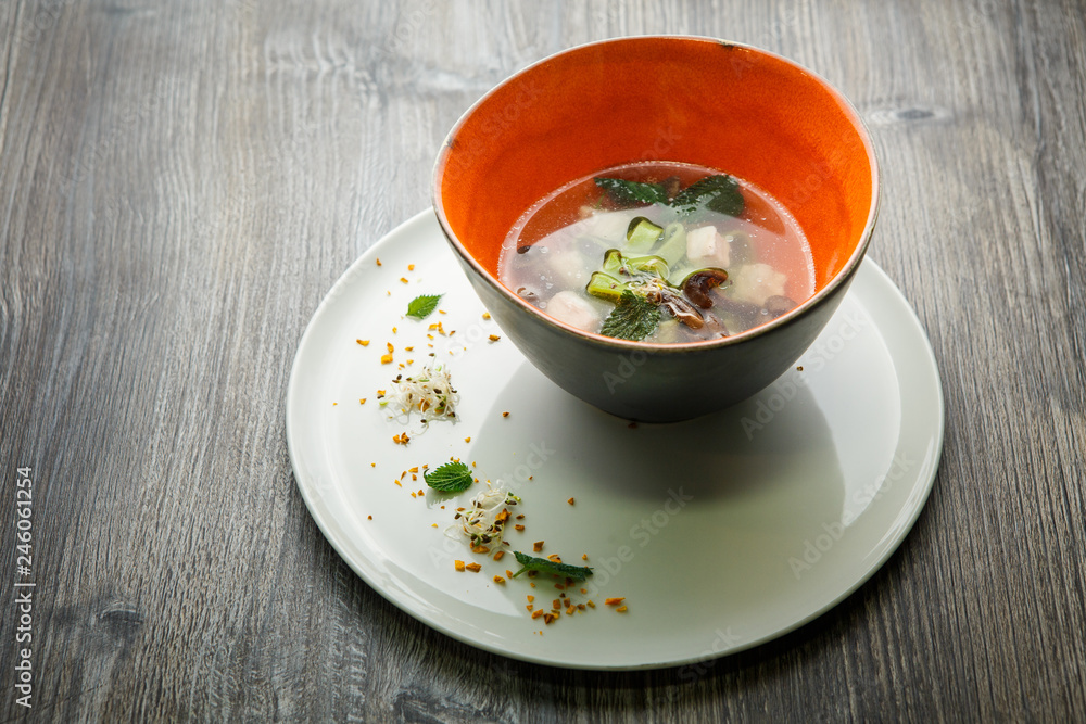 delicious noodle soup with mushrooms, meat, and nettle leaves