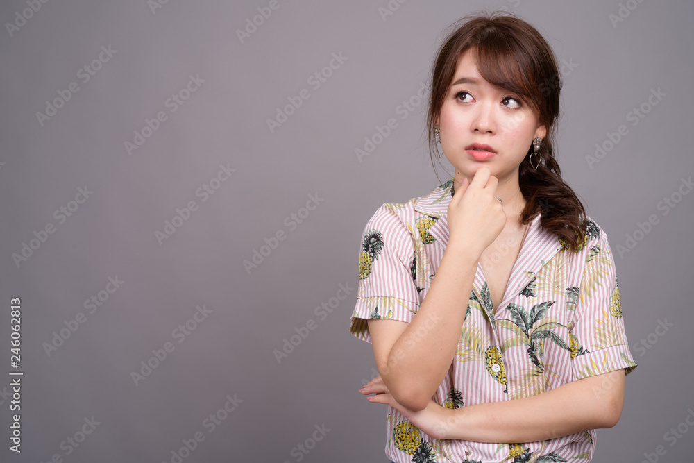 Portrait of young beautiful Asian tourist woman thinking Portrait of young beautiful Asian tourist woman thinking