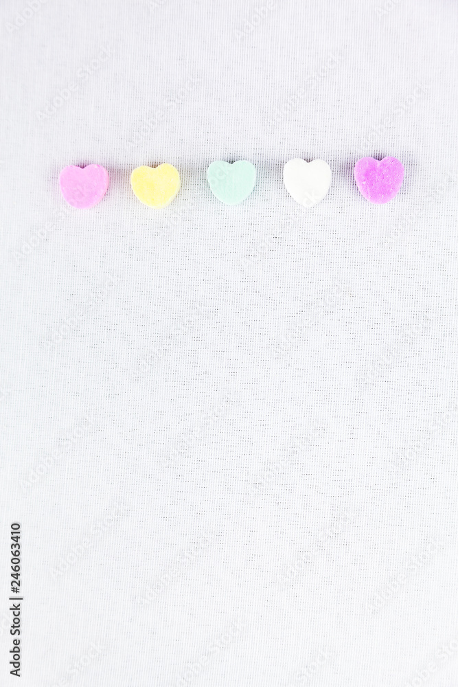 Obraz premium Conversation Hearts Line Up On A White Background