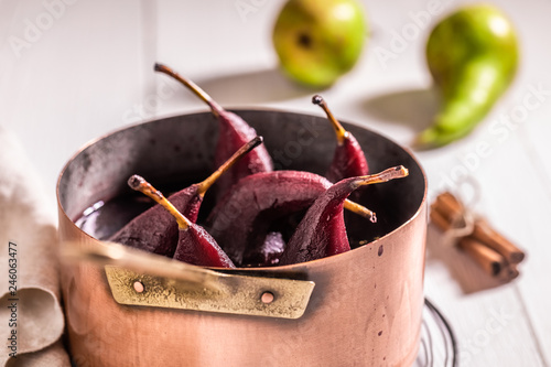 Delicious mulled wine with pears on white table