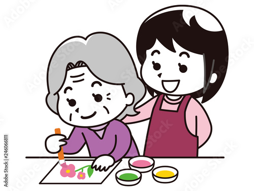 塗り絵を楽しむ高齢女性と女性介護士