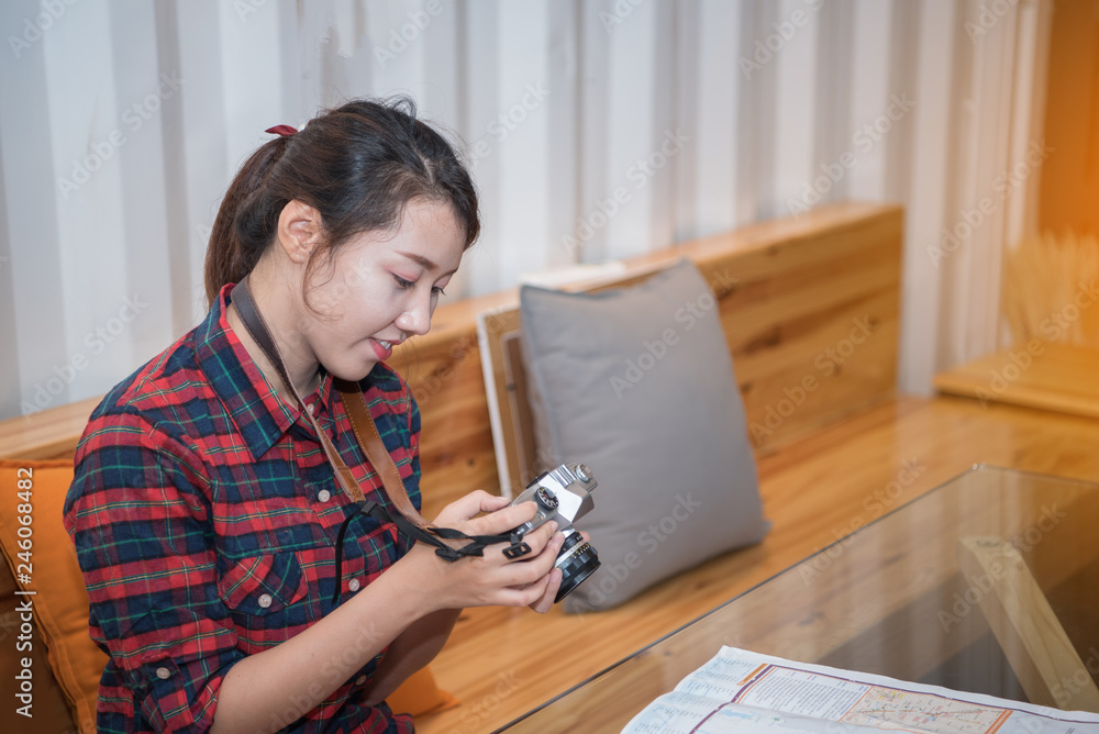 Beautiful young woman tourists with a camera in coffee shop. Beautiful young woman tourists with a camera in coffee shop.