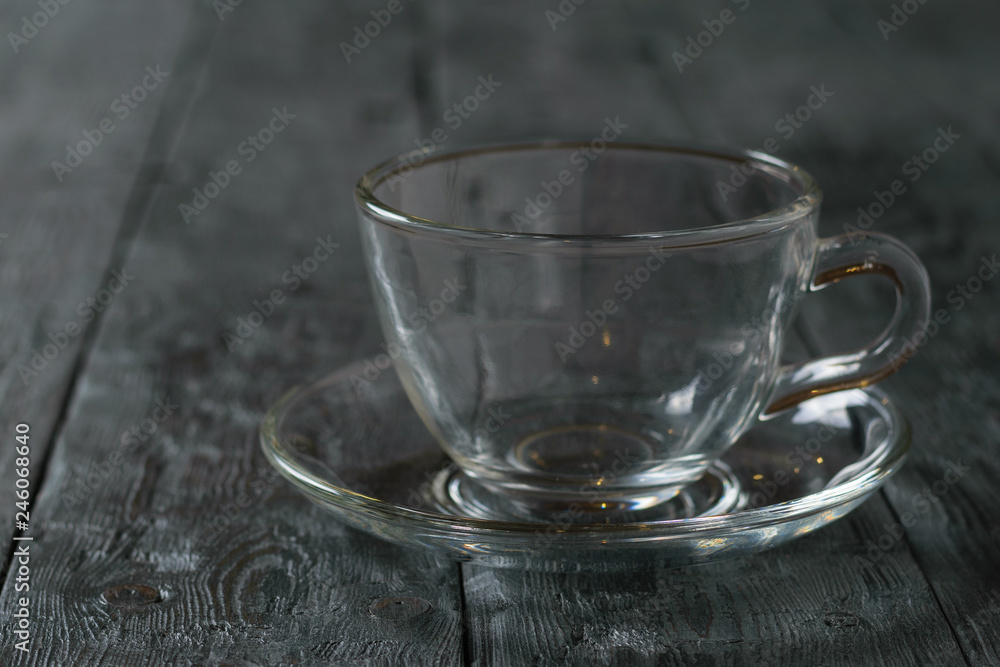 Empty glass Cup with saucer on wooden rustic wooden table. Empty glass Cup with saucer on wooden rustic wooden table.