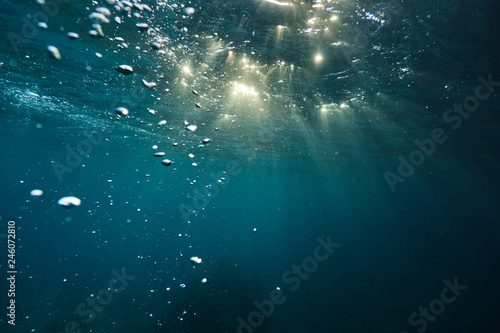 aUnder the waves with light in Hawaii at sunset