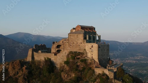 The Sacra di San Michele (Saint Michael's) Abbey, Turin, Italy, sunset shot aerial with mountains of Susa valley in background. Aerial view