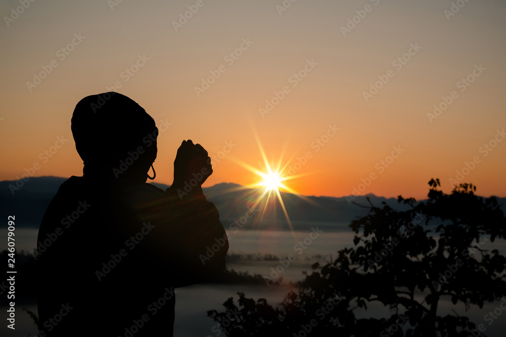Silhouette of christian man hand praying,spirituality and religion,man praying to god. Christianity concept.