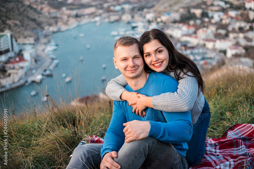 Happy couple seating outdoor near Black sea. Happy couple seating outdoor near Black sea.
