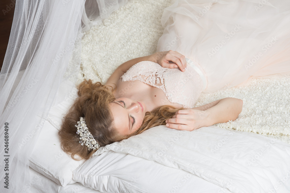Sleeping beauty, which lies on a beautiful bed under a white canopy Sleeping beauty, which lies on a beautiful bed under a white canopy